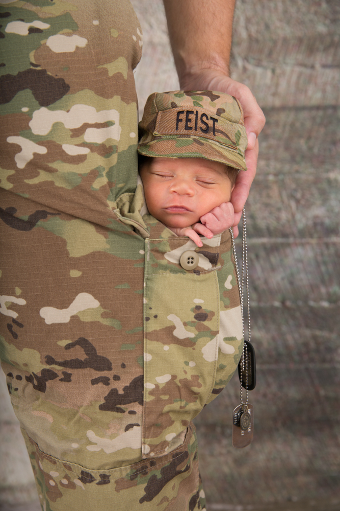 Newborn in military fatigue pocket